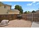 Small backyard area featuring a gravel ground cover, a wooden fence, and a dog house at 17303 E Dewberry Cir, Parker, CO 80134