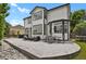 Spacious backyard patio with furniture, outdoor dining, and beautiful landscaping at 17303 E Dewberry Cir, Parker, CO 80134