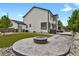 Stunning backyard oasis with a cozy fire pit, artificial grass, and ample space for outdoor entertaining at 17303 E Dewberry Cir, Parker, CO 80134
