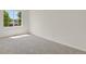 Bedroom featuring neutral carpet and natural light from a large window at 17303 E Dewberry Cir, Parker, CO 80134