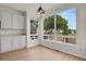 Sunlit dining area showcasing views, wood floors, and modern lighting fixtures at 17303 E Dewberry Cir, Parker, CO 80134