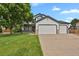 Beautiful two-story home featuring a three-car garage and lush front lawn at 17303 E Dewberry Cir, Parker, CO 80134