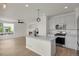 Open kitchen featuring an island with stainless steel appliances, connecting to a fireplace at 17303 E Dewberry Cir, Parker, CO 80134