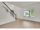 Bright living room featuring hardwood floors, a staircase, and large windows at 17303 E Dewberry Cir, Parker, CO 80134