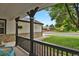 Inviting porch with stone accents, decorative columns, and views of the front yard at 17303 E Dewberry Cir, Parker, CO 80134