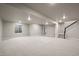 Spacious finished basement with plush carpet, recessed lighting, and staircase at 8244 S Queen St, Littleton, CO 80127