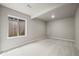 Finished basement featuring plush carpeting, neutral paint, and egress window at 8244 S Queen St, Littleton, CO 80127