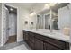 Modern bathroom with double vanity, quartz countertops, and tiled floors at 8244 S Queen St, Littleton, CO 80127