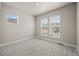 Bright bedroom with plush carpeting and double windows offering ample natural light at 8244 S Queen St, Littleton, CO 80127