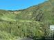 Home on the hill and roadway at 8244 S Queen St, Littleton, CO 80127