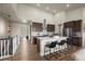 Open kitchen features a large island with seating, modern appliances, and a walk-in pantry at 8244 S Queen St, Littleton, CO 80127