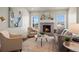 Cozy living room with a fireplace, comfortable seating, and large windows with natural light at 8244 S Queen St, Littleton, CO 80127