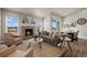 Bright living room with a fireplace, comfortable seating, and sliding doors to the backyard at 8244 S Queen St, Littleton, CO 80127
