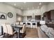 Open concept living room and dining area with modern decor and hardwood floors at 8244 S Queen St, Littleton, CO 80127