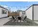 Inviting backyard with a fire pit, string lights, gravel, and concrete at 75 S Knox Ct, Denver, CO 80219