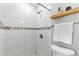 Bright bathroom showcases tiled shower, new fixtures, and neutral color palette at 75 S Knox Ct, Denver, CO 80219