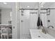 Bright bathroom featuring a white shower, subway tiles, and a sleek vanity with brushed nickel fixtures at 75 S Knox Ct, Denver, CO 80219