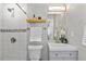 The modern bathroom has a shower over the tub, a neutral vanity, and a mirror at 75 S Knox Ct, Denver, CO 80219