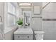 This bathroom offers a large mirror, tiled shower/bath and a neutral vanity at 75 S Knox Ct, Denver, CO 80219