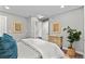 Well-lit bedroom featuring hardwood floors, neutral wall color, and a bed with throw pillows at 75 S Knox Ct, Denver, CO 80219