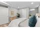 Well-lit bedroom featuring hardwood floors, neutral wall color, and a bed with throw pillows at 75 S Knox Ct, Denver, CO 80219