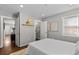 Comfortable bedroom featuring an ensuite bathroom, neutral paint, and plenty of light at 75 S Knox Ct, Denver, CO 80219