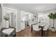 Open dining area with sleek table and modern chandelier lighting at 75 S Knox Ct, Denver, CO 80219