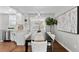 Bright dining area with modern lighting, decor, and access to kitchen at 75 S Knox Ct, Denver, CO 80219