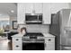 This beautifully updated kitchen offers white cabinets, stainless appliances and subway tile backsplash at 75 S Knox Ct, Denver, CO 80219