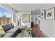 Bright living room featuring hardwood floors and comfortable gray sofa at 75 S Knox Ct, Denver, CO 80219