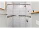Modern bathroom shower with white tile and elegant silver accent trim at 75 S Knox Ct, Denver, CO 80219
