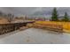 Outdoor patio featuring a built-in stone bench, a cozy fire pit and decorative concrete at 13601 Krameria St, Thornton, CO 80602