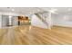Spacious finished basement with wood-look flooring, wet bar, and staircase at 13601 Krameria St, Thornton, CO 80602