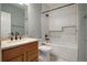 Bathroom with granite countertop vanity, white subway tile, and mosaic-tiled niche and tub surround at 13601 Krameria St, Thornton, CO 80602
