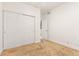 A carpeted bedroom with a closet and a door leading outside of the room at 13601 Krameria St, Thornton, CO 80602
