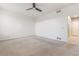A spacious bedroom with neutral carpet, ceiling fan, and a doorway visible on the right at 13601 Krameria St, Thornton, CO 80602
