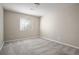 Empty bedroom with carpet and neutral paint with a window offering natural light at 13601 Krameria St, Thornton, CO 80602