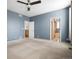 Carpeted bedroom with a ceiling fan, leading to an en-suite bathroom and closet at 13601 Krameria St, Thornton, CO 80602