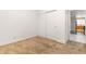 A carpeted bedroom with a closet and a door leading to another room at 13601 Krameria St, Thornton, CO 80602