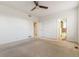 A carpeted bedroom features two doorways, neutral walls, and a ceiling fan at 13601 Krameria St, Thornton, CO 80602