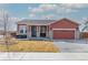 Charming single-Gathering home featuring a well-maintained lawn, covered porch, and a two-car garage at 13601 Krameria St, Thornton, CO 80602