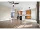 Open concept kitchen featuring warm cabinets, stainless appliances and bar seating that flows to the living area at 13601 Krameria St, Thornton, CO 80602
