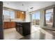 Charming kitchen features an island, maple cabinets, granite countertops and access to an outdoor space at 13601 Krameria St, Thornton, CO 80602