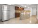 A stainless refrigerator and lovely backsplash enhance this charming kitchenette at 13601 Krameria St, Thornton, CO 80602