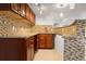Cherry cabinets and granite countertops accent this charming kitchenette area at 13601 Krameria St, Thornton, CO 80602