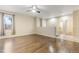 Spacious living room with hardwood floors, neutral paint and great light perfect for relaxing and entertaining at 13601 Krameria St, Thornton, CO 80602