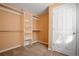 Walk-in closet complete with a carpeted floor, shelving, and a door at 13601 Krameria St, Thornton, CO 80602