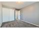 Bright bedroom with gray walls, carpet flooring, and a double door closet at 5545 E 130Th Dr, Thornton, CO 80241