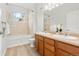 Bright bathroom with double sinks, a tub-shower combination, and modern fixtures at 3329 Molly Ln, Broomfield, CO 80023