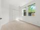 Bright bedroom with large windows, a spacious closet, and neutral carpeting at 3329 Molly Ln, Broomfield, CO 80023